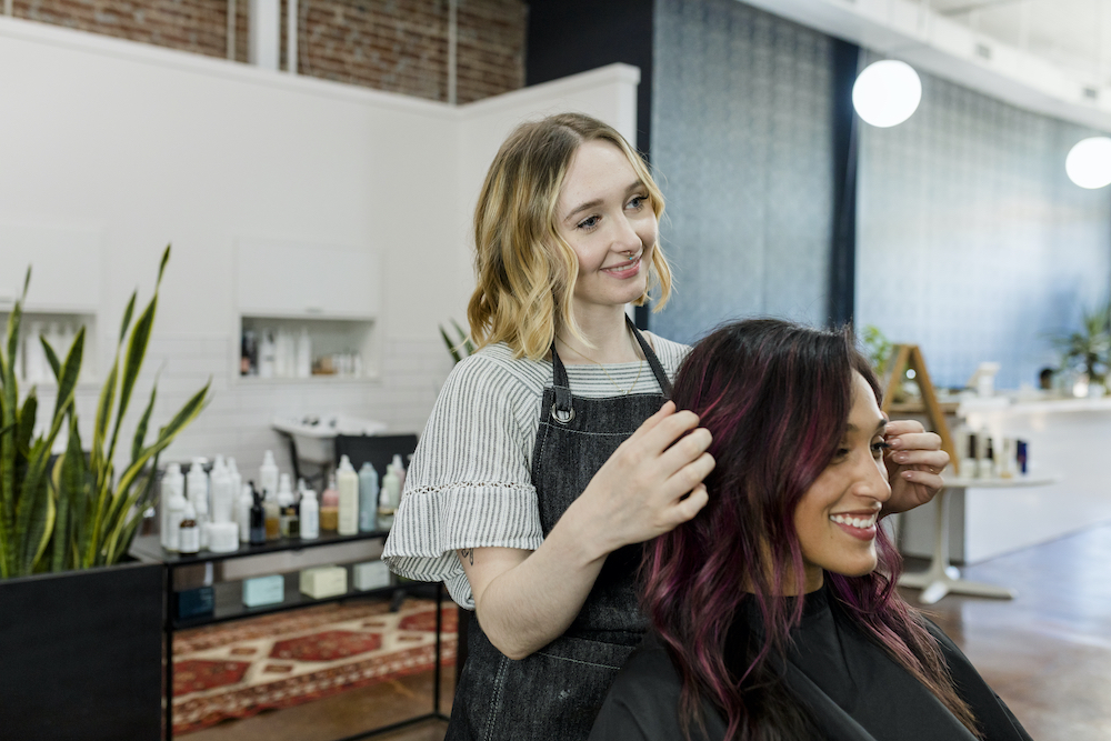 Hairstylist giving a haircut to a customer at a beauty salon